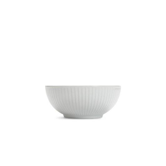 White ceramic bowl with ribbed texture on a white background