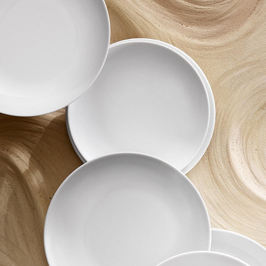 White ceramic bowls on a wooden surface