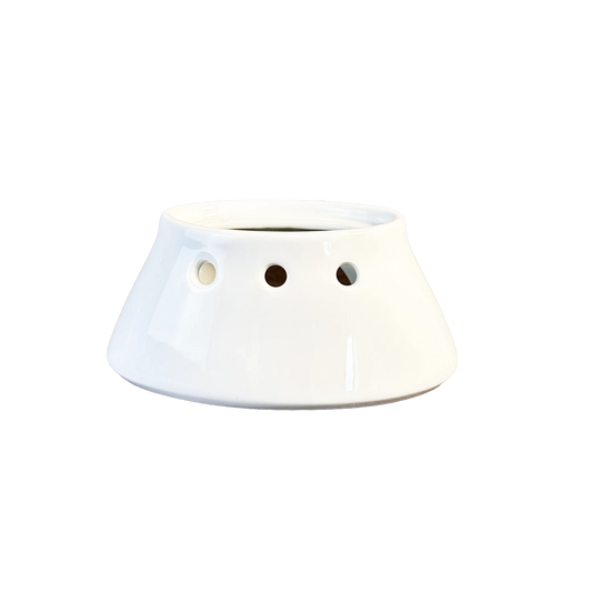 White ceramic planter with three holes on a white background