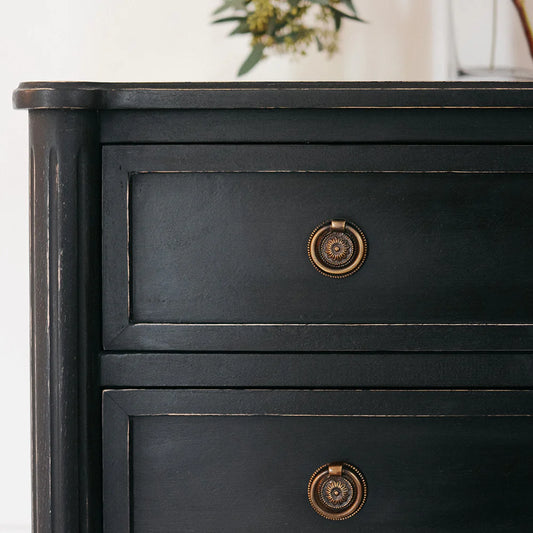 ring rosette drawer pull on black dresser