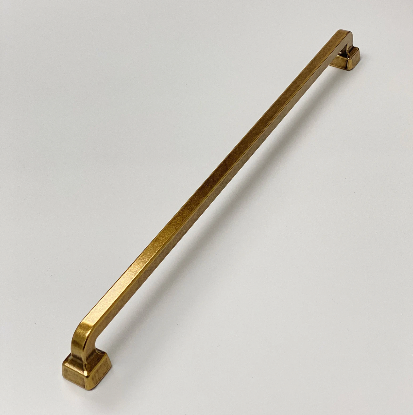 Gold cabinet handle on a white background