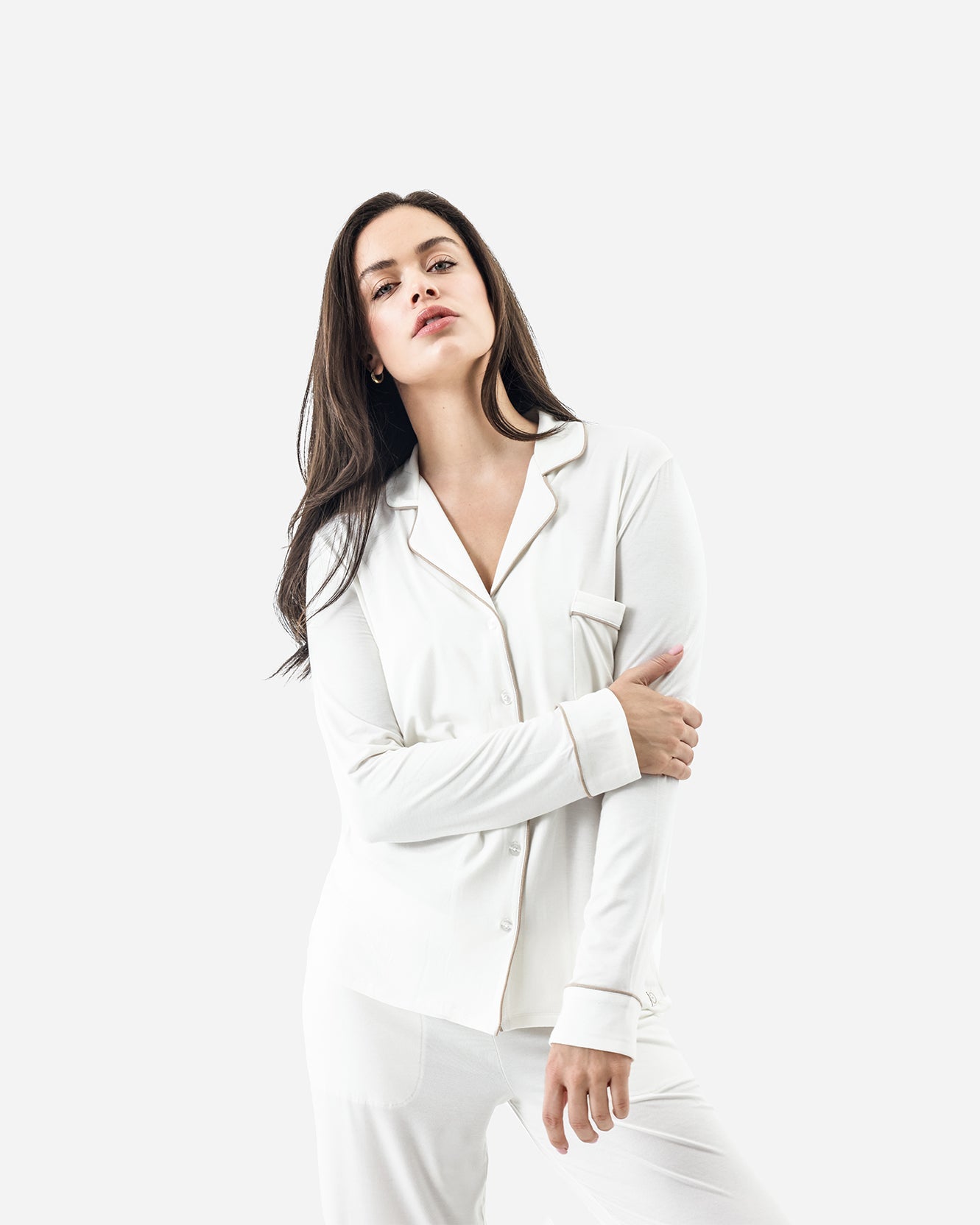 Woman wearing a white satin shirt against a white background