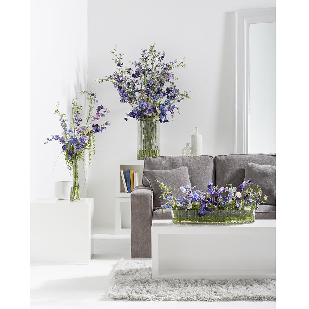 Artificial Faux Sweet Pea Arrangement in Ribbed Glass Vase with several arrangements in the room