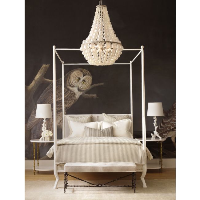 Neoclassical-style bed with white canopy and chandelier in a bedroom setting.