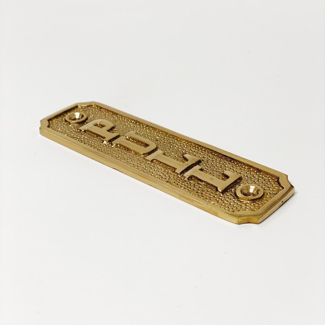 Brass Door plaque that says PULL and is mounted vertically