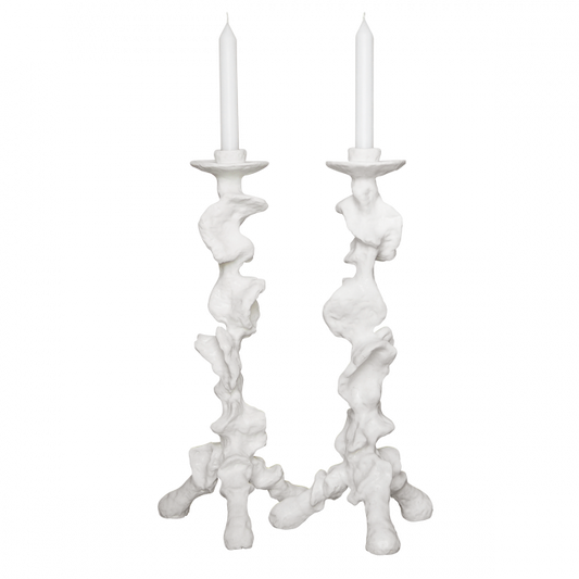 Two white candle holders with candles on a white background
