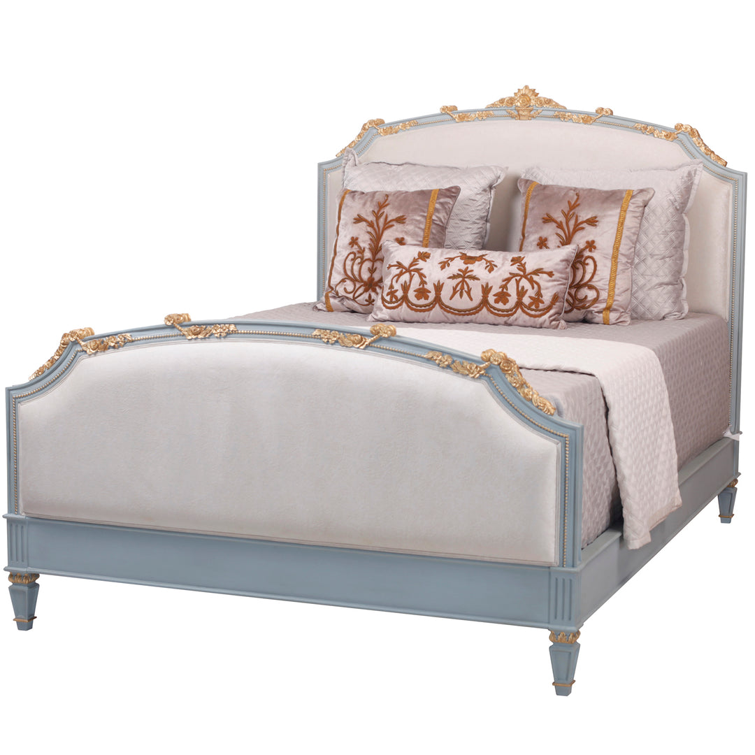 Adorable headboard and footboard are enhanced with curved legs, carvings, and creme upholstery.