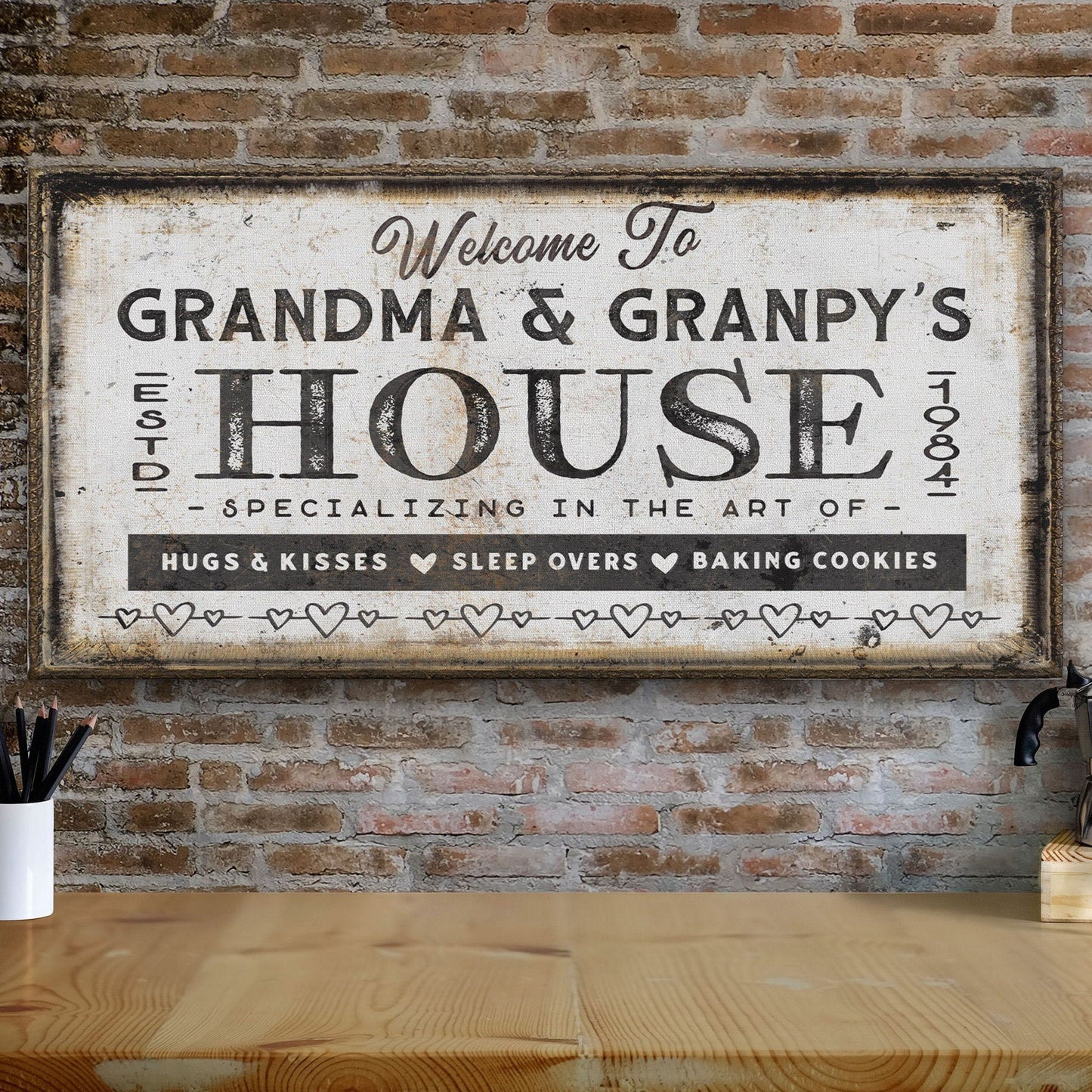 Decorative sign reading 'Welcome to Grandma & Granpy's House' on a brick wall.