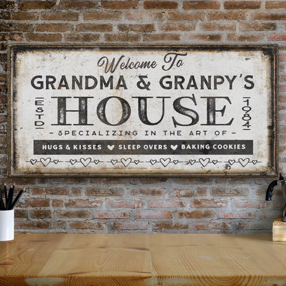 Decorative sign reading 'Welcome to Grandma & Granpy's House' on a brick wall.