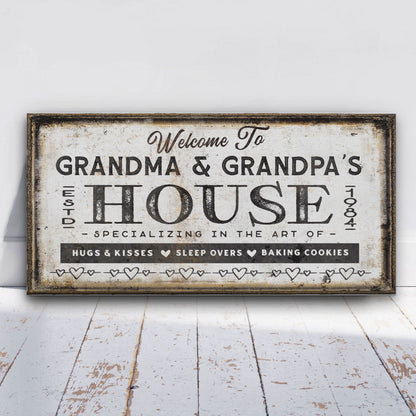 Decorative sign reading 'Welcome to Grandma & Grandpa's House' on a white wooden floor.