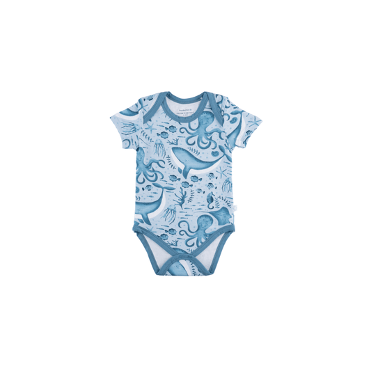 Baby onesie with blue ocean-themed design on a white background
