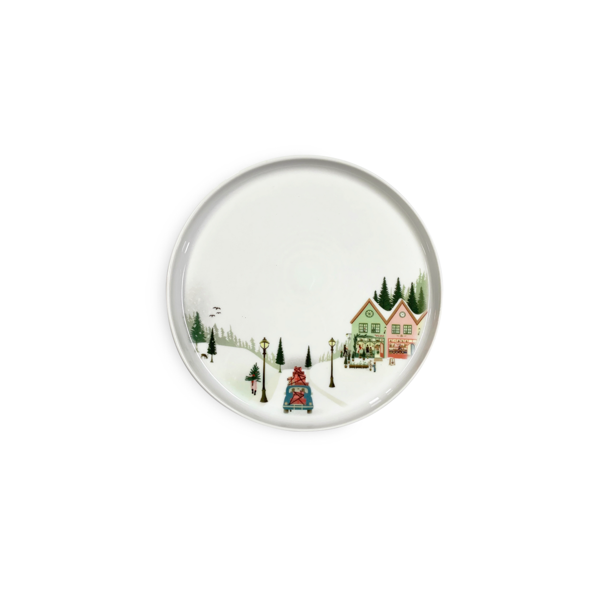 Round ceramic plate with a winter scene design featuring houses and trees on a white background