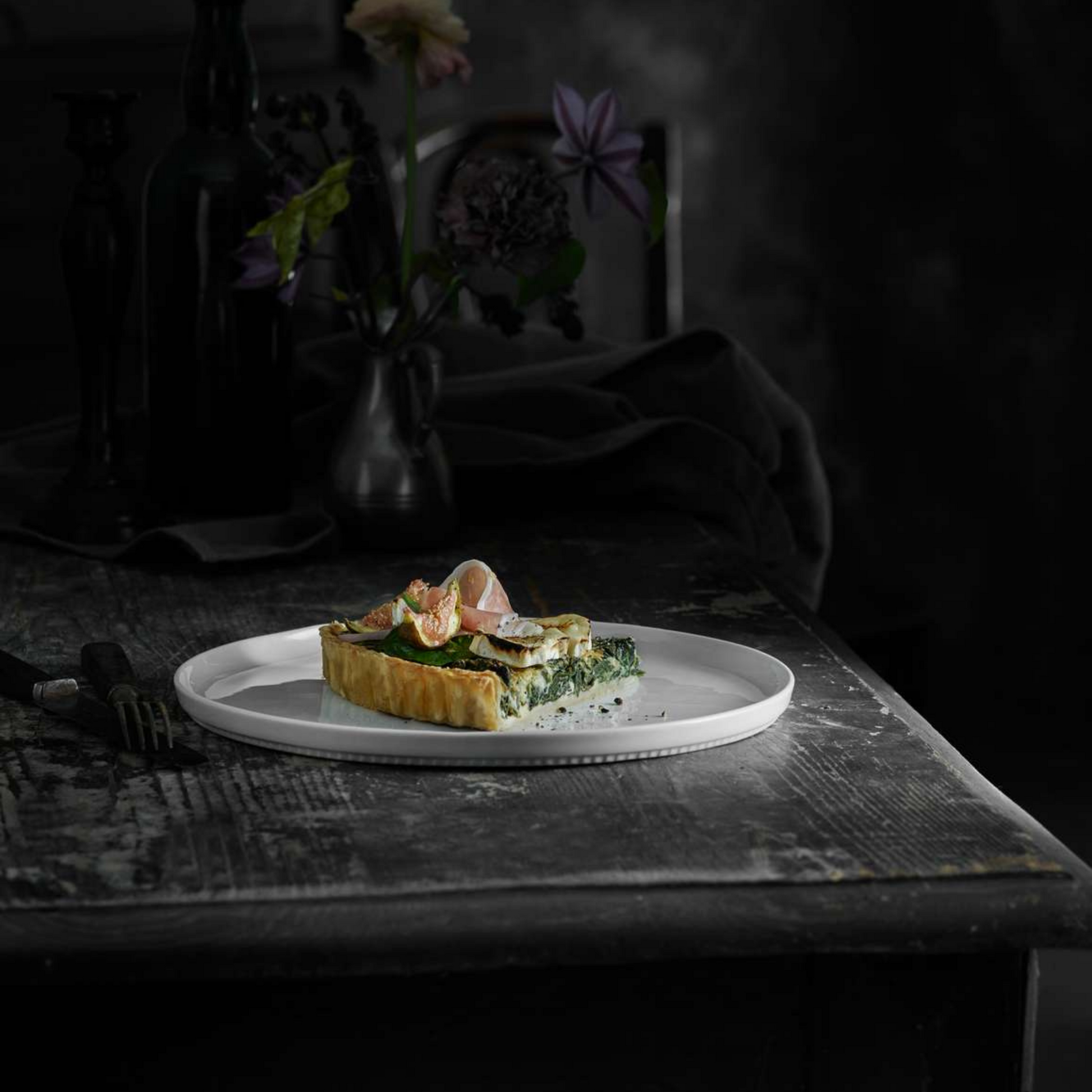 Small dish of food on a white plate with a dark background