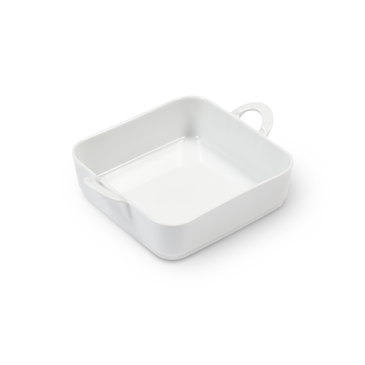 White ceramic dish with a handle on a white background