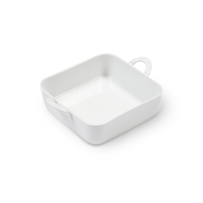 White ceramic dish with a handle on a white background