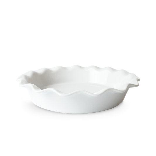 White ceramic pie dish with ruffled edge on a white background