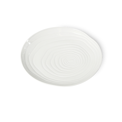 White ceramic plate with spiral design on a white background