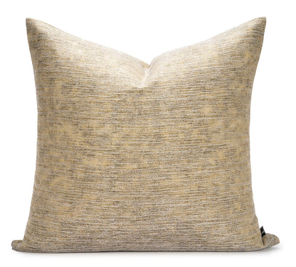 Textured beige pillow on a white background