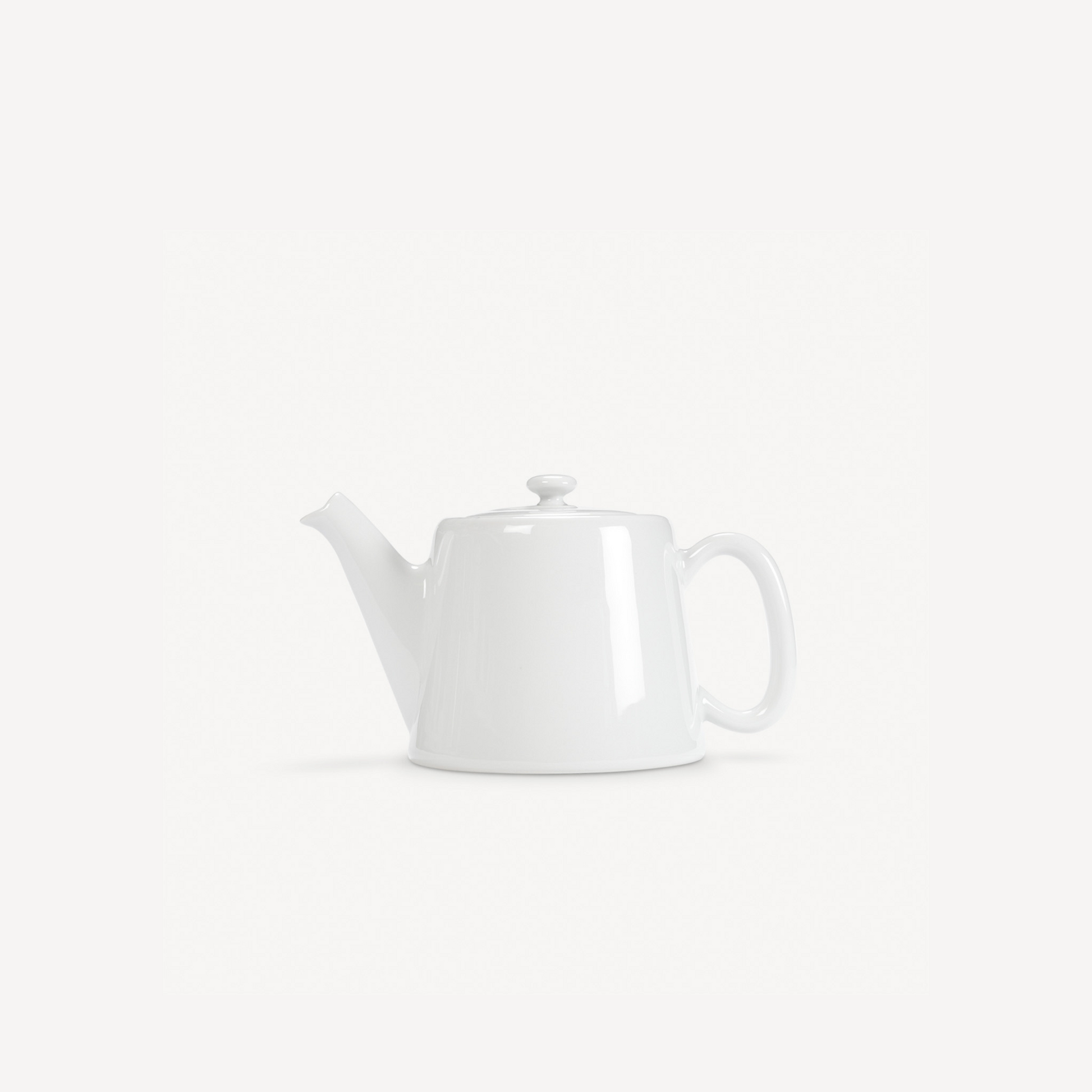 White ceramic teapot on a light gray background