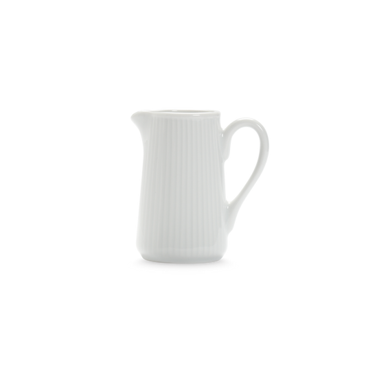 White ceramic pitcher with a handle on a white background