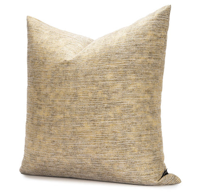 Textured gold and black pillow on a white background