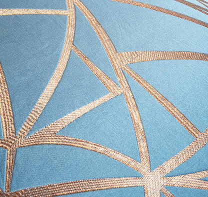 Close-up of geometric pattern on fabric with blue background