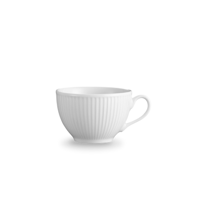 White ceramic cup with ribbed texture on a white background