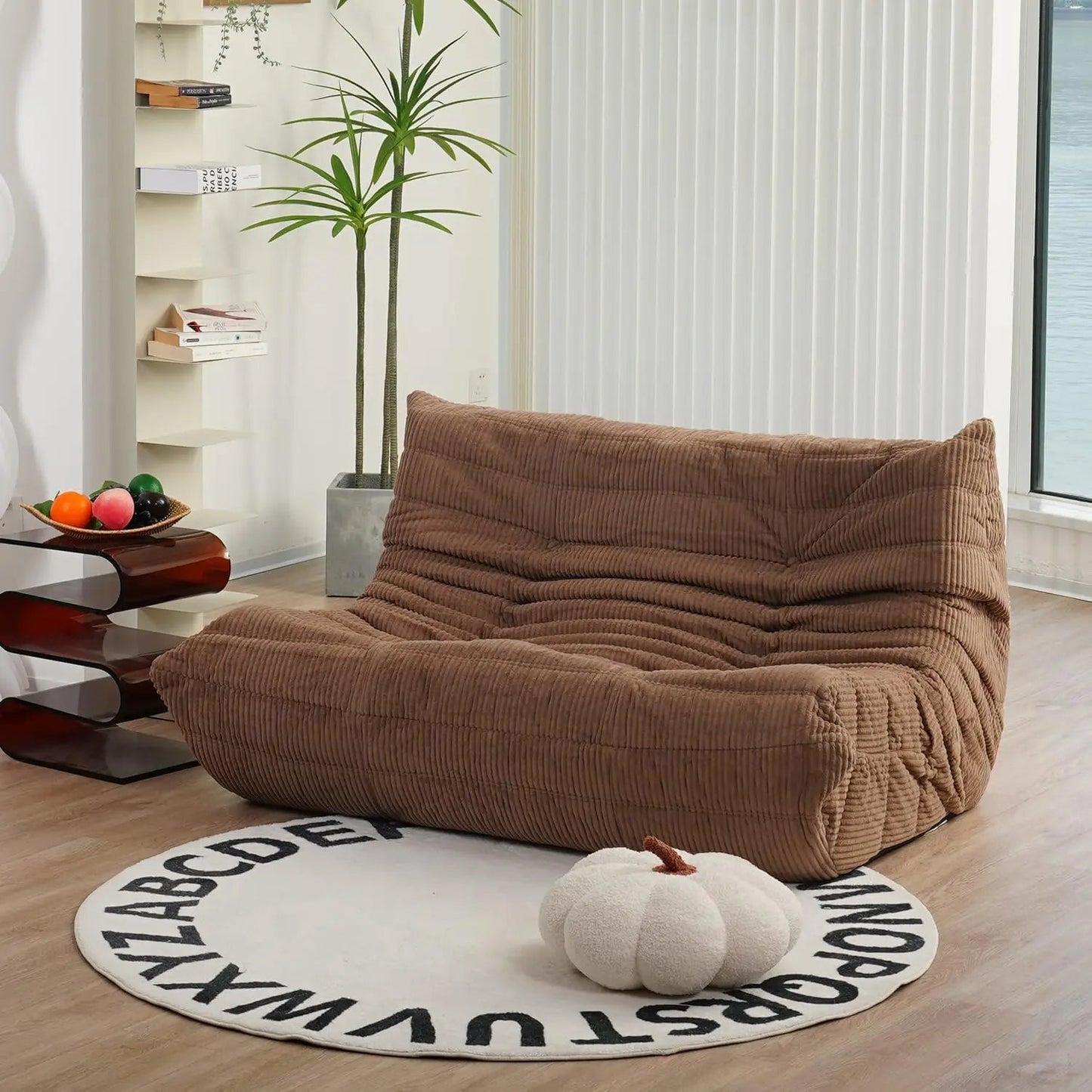 Brown corduroy bean bag loveseat sofa styled in a cozy living room with warm wood tones and soft textures.