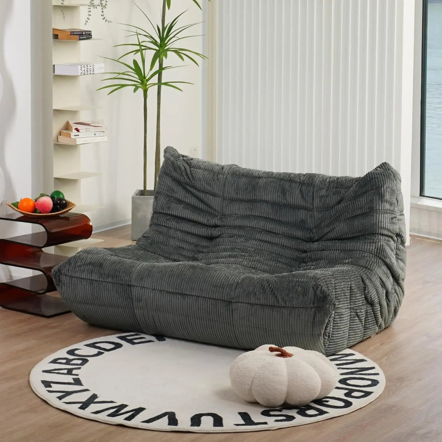 Dark Grey corduroy bean bag loveseat sofa styled in a cozy living room with warm wood tones and soft textures.