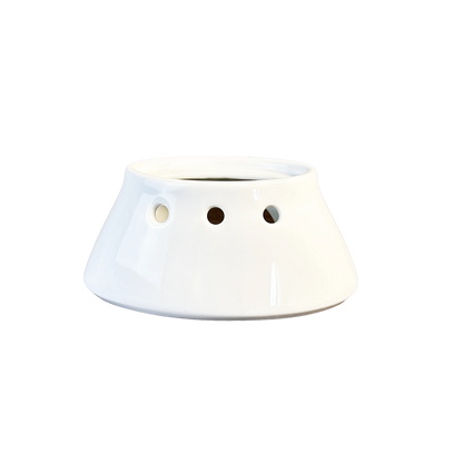 White ceramic planter with three holes on a white background