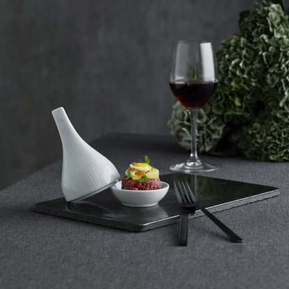 Dessert with a glass of red wine on a dark surface