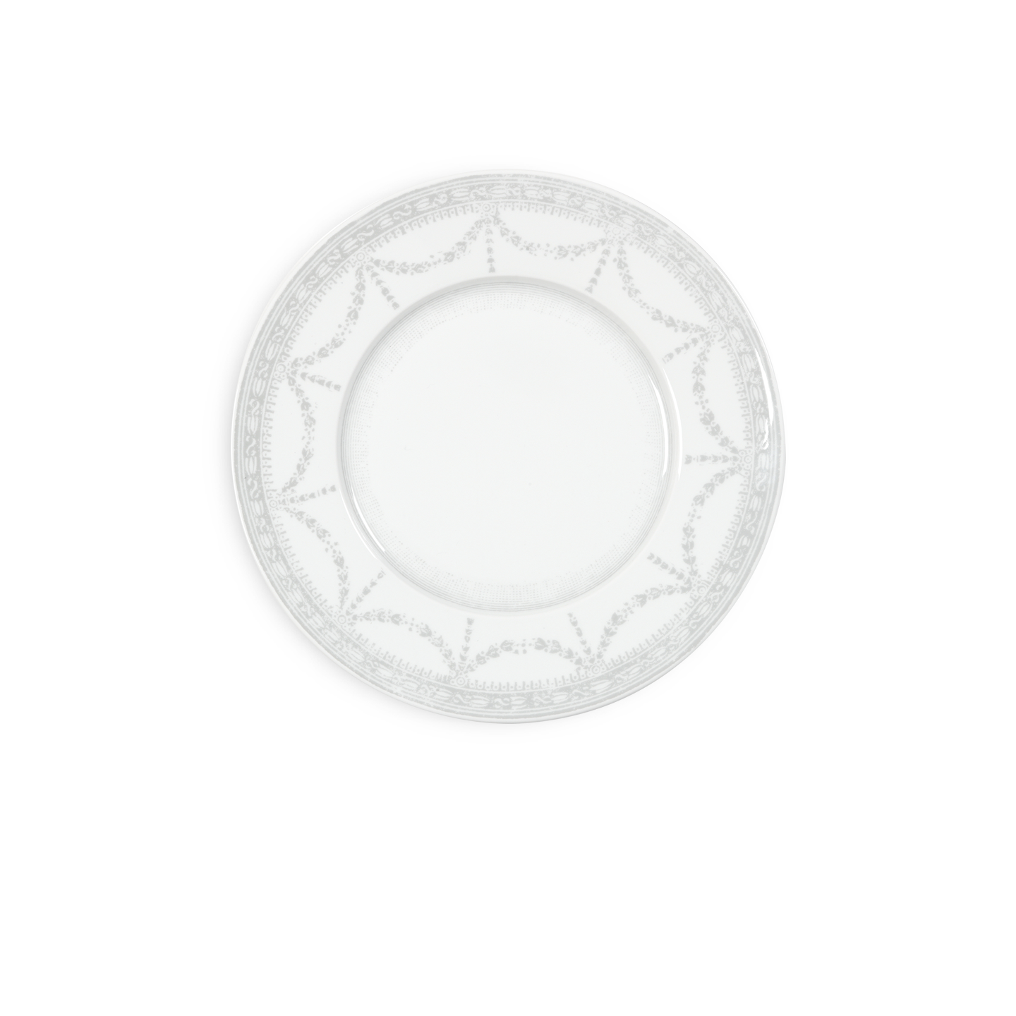 White decorative plate with intricate patterns on a white background