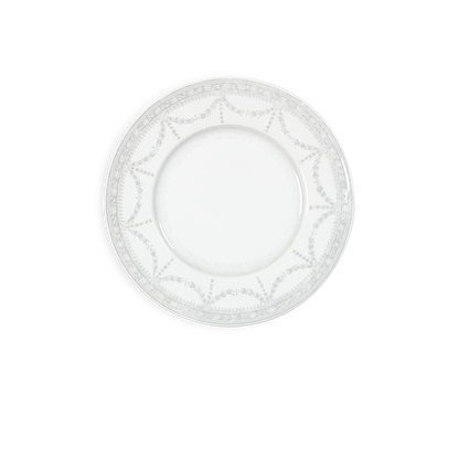 White decorative plate with intricate patterns on a white background