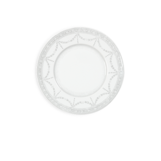White decorative plate with intricate patterns on a white background