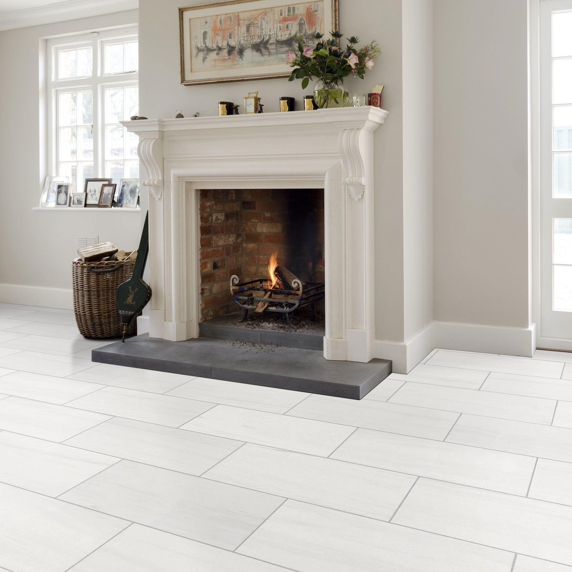 White tiled floor with a fireplace in a room with light gray walls and a window.