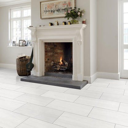 White tiled floor with a fireplace in a room with light gray walls and a window.