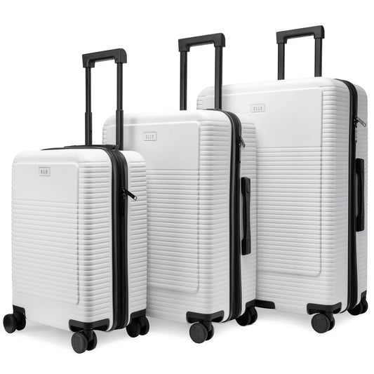 Set of three white suitcases with black handles and wheels on a white background