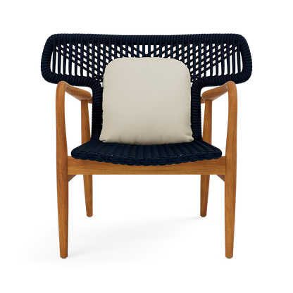 Chair with wooden frame and navy woven backrest and seat, featuring a cream leather cushion.