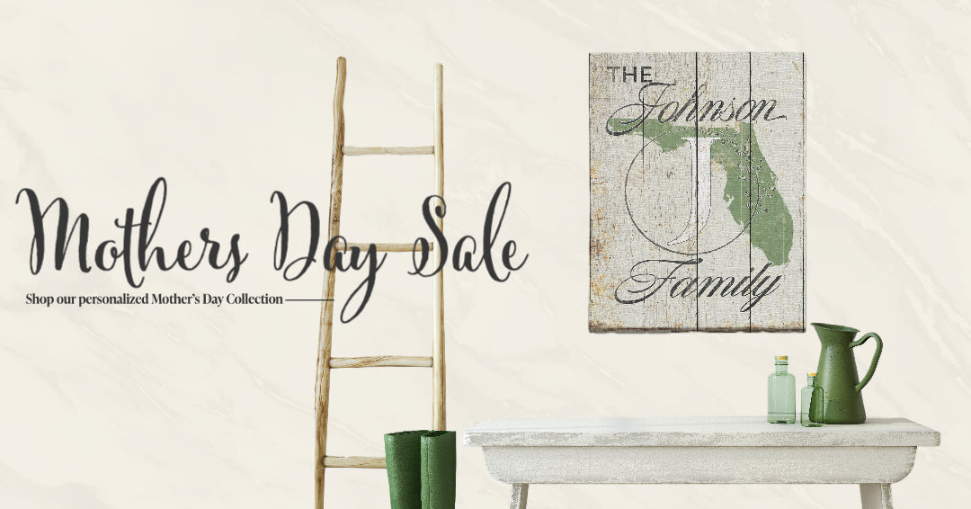 Decorative sign with 'The Johnson Family' on a white wall, with a ladder and green vase in the foreground.