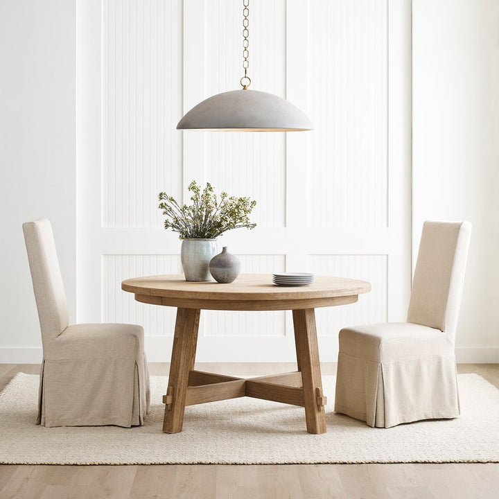 Elliot Grande Pendant Portland Grey show over small round dining room table