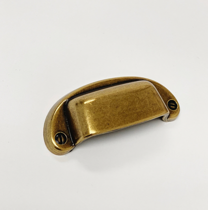 Brass cabinet handle on a white background