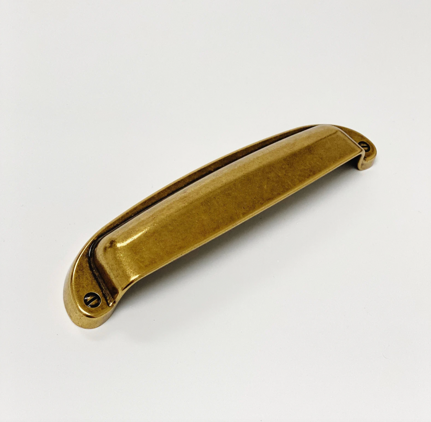 Gold cabinet handle on a white background