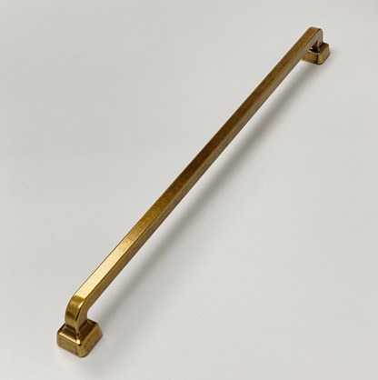 Gold cabinet handle on a white background
