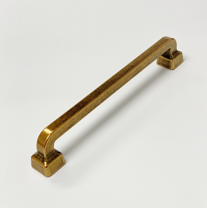 Brass cabinet handle on a white background