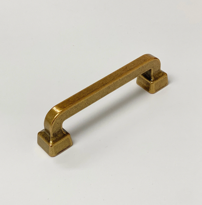 Brass cabinet handle on a white background