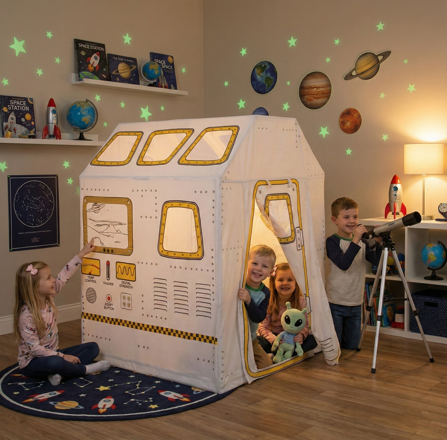 Children playing in a space-themed playhouse with space-themed decor in the room.