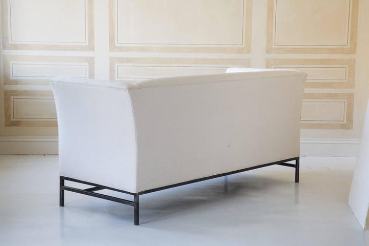 Contemporary Linen Sofa with Iron Base by Tara Shaw shown with the back view.