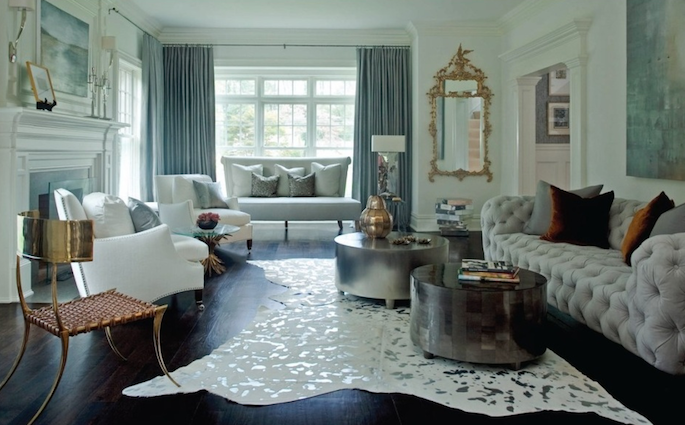 Living room with white sofa, coffee table, and decorative elements.