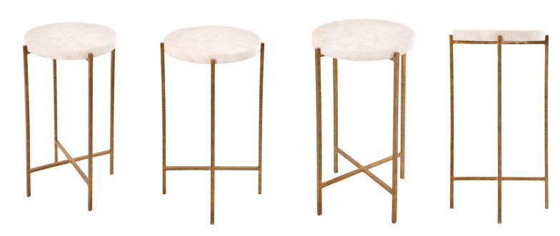 Four gold bar stools with white cushioned seats on a white background
