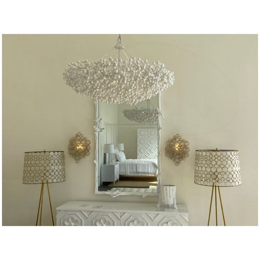 Decorative chandelier, mirror, and lamps in a room setting.